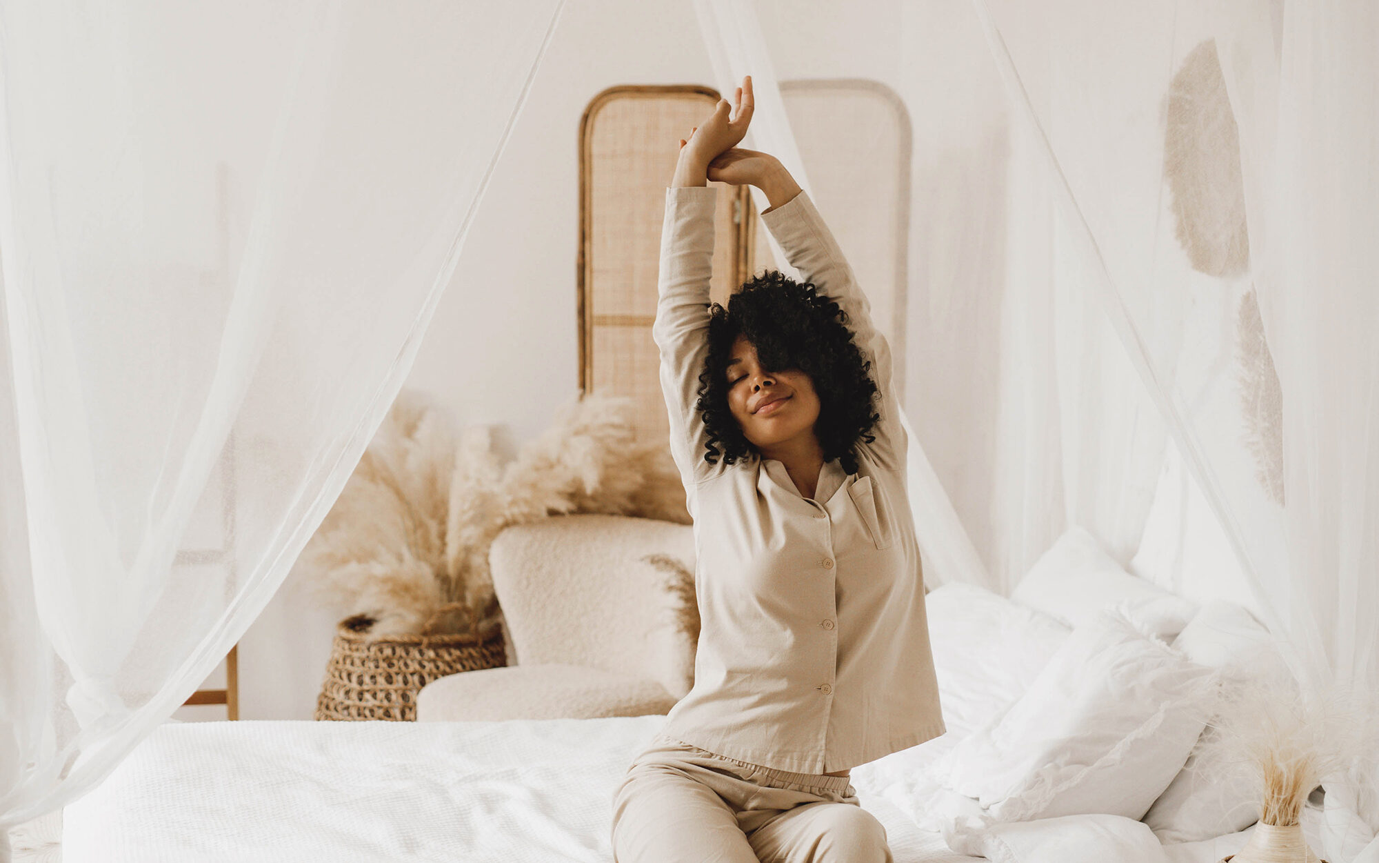 image of black woman stretching on bed