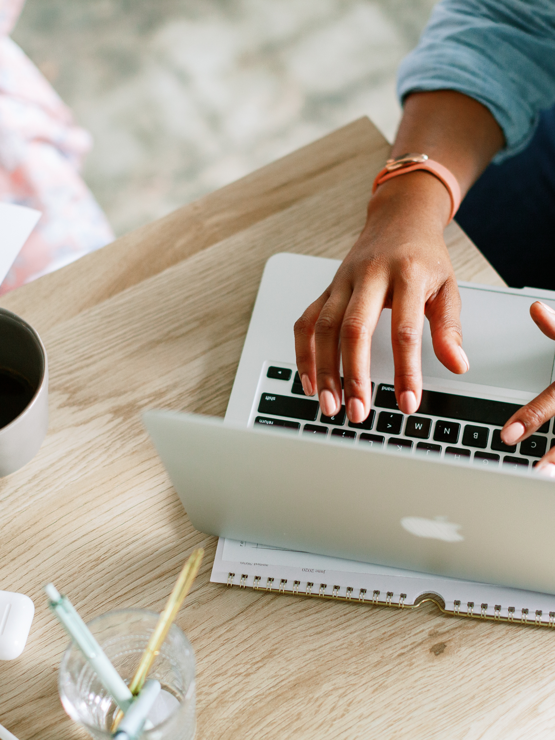 Woman on laptop on a blog post about perfectionist types in motherhood.