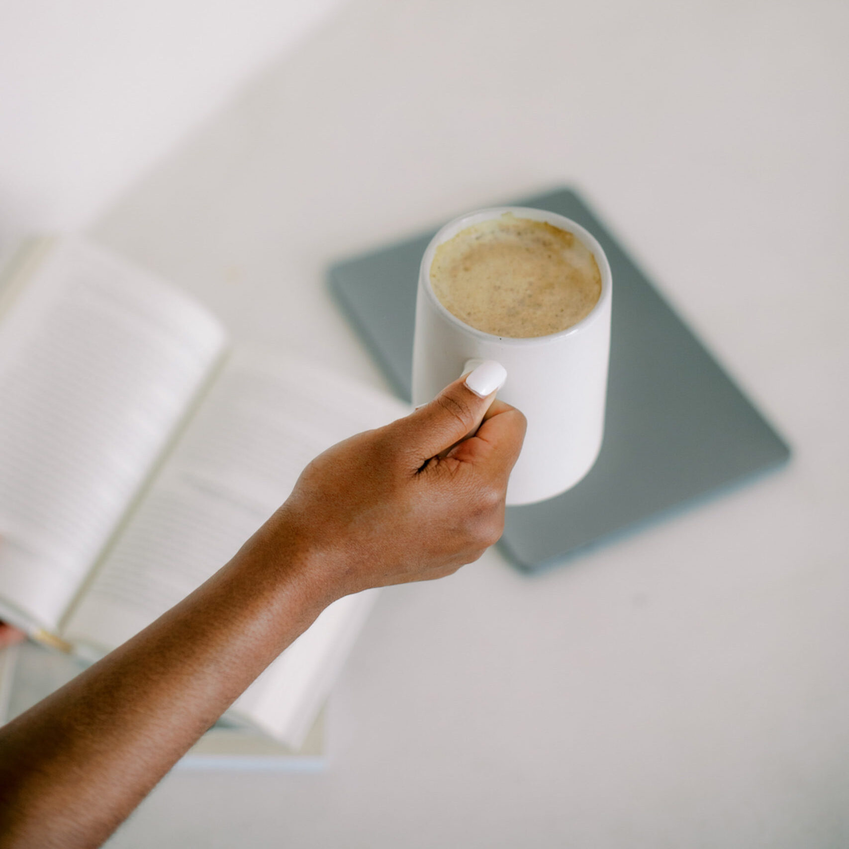 image of a black woman holding a coffee cup on a website for therapy for busy moms