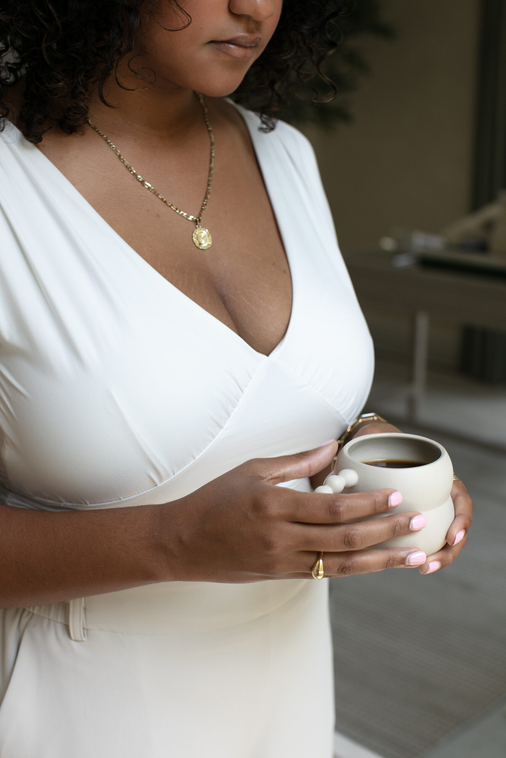 an image of a black woman holding a cup on a website for therapy for depleted mothers of color