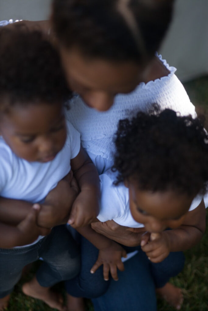 image of woman and children on a blog post about types of capacity in motherhood for moms of color