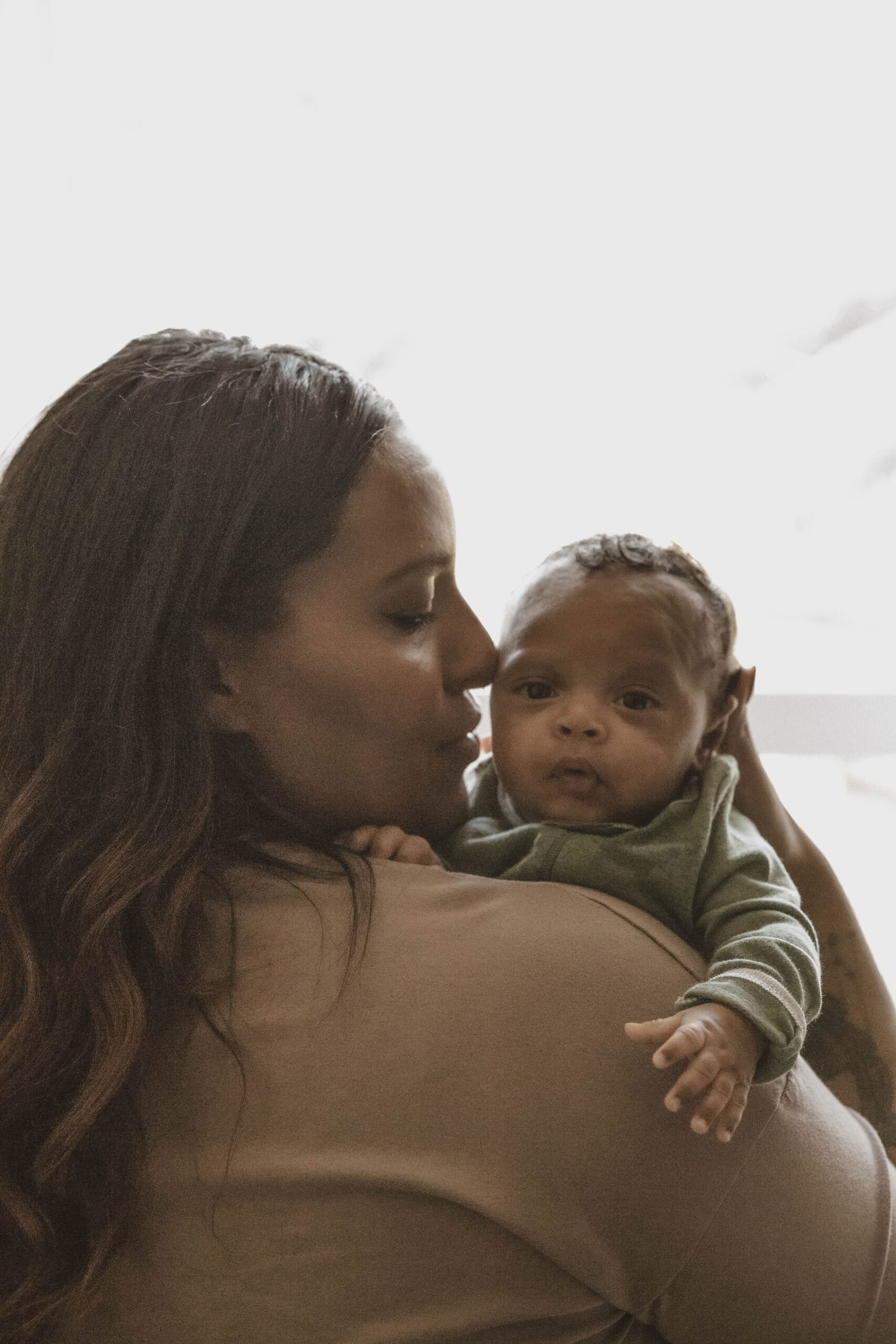 therapist vanessa leveille holding her son on a blog post about inner split for mothers of color in matrescence